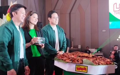 <p><strong>GASTRONOMY TOURISM.</strong> Department of Tourism Assistant Secretary Gissela Marie Quisumbing (center) receives a miniature Mang Inasal Store from Mang Inasal president Mike Castro (left) during the launch of Love the Flavors, Love the Philippines campaign on Monday (Sept. 23, 2024) in Quezon City. The campaign seeks to connect tourists with Filipino culture through local cuisine and improve the country's tourism economy. <em>(PNA photo by Ma. Teresa P. Montemayor)</em></p>