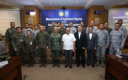 <p><strong>DEV’T COOPERATION.</strong> Armed Forces of the Philippines deputy chief of staff Lt. Gen. Charlton Sean Gaerlan and National University president Dr. Renato Carlos Ermita Jr. (front row, fourth and fifth from left, respectively) lead the signing of a Memorandum of Agreement between the AFP and NUP at the AFP general headquarters in Camp Aguinaldo, Quezon City on Tuesday (Sept. 24, 2024). The partnership paves the way for a range of opportunities to support the personal and professional growth of AFP personnel, their dependents, and NU students. <em>(Photo courtesy of the AFP)</em></p>