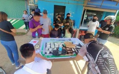 <p><strong>DRUG BUST.</strong> PDEA operatives in Zamboanga Peninsula account for PHP6.8 million worth of shabu seized from two suspects (seated) during a buy-bust operation in Zamboanga City on Tuesday (Sept. 24, 2024). In a separate operation in Ipil, Zamboanga Sibugay, three college students were arrested inside a drug den, where authorities confiscated PHP68,000 worth of shabu. <em>(Photo courtesy of PDEA-9)</em></p>