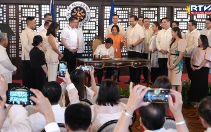 <p><strong>MORE TEETH.</strong> President Ferdinand R. Marcos Jr. signs Republic Act No. 12022 or the Anti-Agricultural Economic Sabotage Act before members of both houses of Congress, Cabinet members, and other agriculture stakeholders in a ceremony at Malacañang Palace on Thursday (Sept. 26, 2024). A priority measure of the administration, the new law makes agricultural smuggling, hoarding, profiteering, cartel and financing of these crimes classified as acts of economic sabotage and will carry a penalty of life imprisonment and hefty fines. <em>(RTVM Screengrab)</em></p>