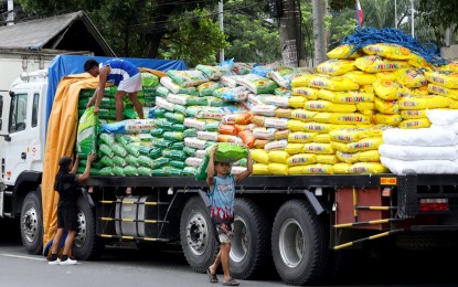 <p><strong>RICE PRICE DROP.</strong> Workers move sacks of rice to another truck on Dagupan Street in Tondo, Manila on Sept. 9, 2024. Agriculture Secretary Francisco Tiu Laurel Jr., meanwhile, remained hopeful on Thursday (Sept. 26) for the continuous drop of retail rice in the coming months. <em>(PNA file photo by Yancy Lim)</em></p>