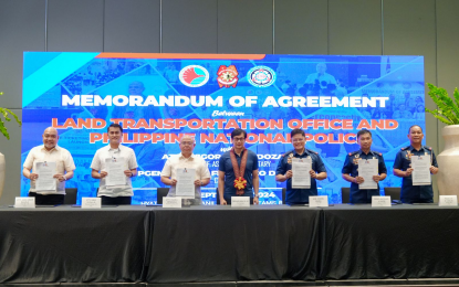 <p><strong>ANTI-MOTORCYCLE THEFT</strong>. Interior and Local Government Secretary Benhur Abalos Jr. (center) witnesses the signing of a memorandum of agreement between the Philippine National Police and Land Transportation Office at a Parañaque City hotel on Thursday (Sept. 26, 2024). The information and communications technology pact seeks to address motorcycle theft cases. <em>(Photo courtesy of (DILG)</em></p>