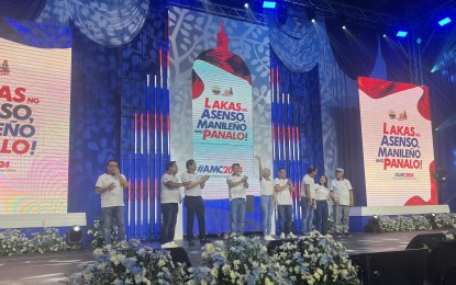 <p><strong>UNITED FRONT.</strong> Asenso Manileño's candidates for the May 2025 polls, led by Vice Mayor Yul Servo and party president and Manila Mayor Honey Lacuna (4th and 5th from left), hold the party convention at San Andres Sports Complex in Malate on Friday afternoon (Sept. 27, 2024). Also seeking reelection are 2nd District Rep. Rolando Valeriano, 3rd District Rep. Joel Chua, 4th District Rep. Edward Maceda, 5th District Rep. Irwin Tieng and 6th District Rep. Benny Abante, while former congressman Manny Lopez will try to return to the 1st District.<em> (PNA photo by FGP)</em></p>