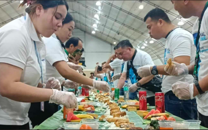 <p><strong>SEAFARERS DAY.</strong> Filipino seafarers partake in a boodle fight prepared by the Department of Migrant Workers during the “Alay sa Marinong Pilipino” event at the Philippine International Convention Center in Pasay City on Friday (Sept. 27. 2024). In a speech, Migrant Workers Secretary Hans Leo Cacdac highlighted the Filipino seafarer's skills, dedication, and resilience that make them one of the most sought-after in the shipping industry. <em>(PNA photo by Marita Moaje)</em></p>