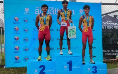 <p><strong>FASTEST.</strong> Joshua Alexander Ramos (silver), Andrew Kim Remolino (gold) and Matthew Justine Hermosa (bronze) (from left) are top finishers in the National Age Group Aquathlon 2024 men's elite held at Ayala Vermosa Sports Hub in Imus, Cavite on Sunday (Sept. 29, 2024). It is part of the country's preparations for the 2025 Thailand Southeast Asian Games.<em> (PNA photo by Jean Malanum)</em></p>