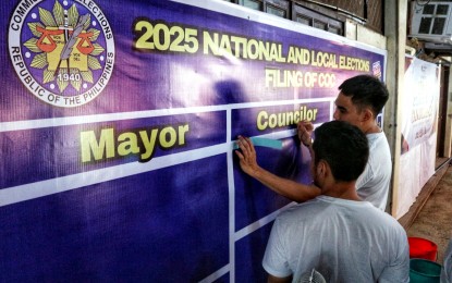 <p><strong>ELECTION FEVER.</strong> Employees of the Commission on Elections in Davao City set up tarpaulins for candidate listings on Monday (Sept. 30, 2024), ahead of the start of the filing of certificates of candidacy (COCs) for the 2025 midterm polls. The Philippine National Police said 36,000 police officers would be deployed nationwide to secure the filing of COCs which starts on Tuesday (Oct. 1). <em>(PNA photo by Robinson Niñal)</em></p>