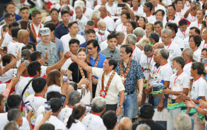 <p><strong>‘STATISTICALLY STABLE’</strong>. President Ferdinand R. Marcos Jr. acknowledges the crowd as he enters the Eduardo Cojuangco gymnasium in Paniqui town, Tarlac province to lead the distribution of Certificates of Conditions with Release of Mortgage (COCROMs) to 3,527 farmers on Monday (Sept. 30, 2024). President Marcos maintained “statistically stable” approval and trust ratings for the third quarter of 2024, according to Publicus Asia survey released on Sept. 30. <em>(Photo from Bongbong Marcos FB page)</em></p>