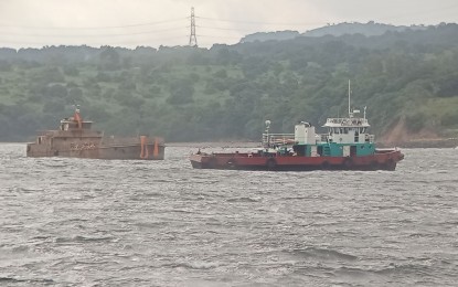 <p><strong>TOWED.</strong> Tugboat MTUG Challenger towed the refloated tanker MTKR Jason Bradley along the shoreline of Mariveles, Bataan for docking in Orion, Bataan on Sept. 29, 2024. The Philippine Coast Guard (PCG) on Tuesday (Oct. 1) said administrative cases have been filed against the operators of MTKR Jason Bradley and MV Mirola 1 -- two of the three vessels that sank off the coast of Bataan in July. <em>(Photo courtesy of PCG)</em></p>