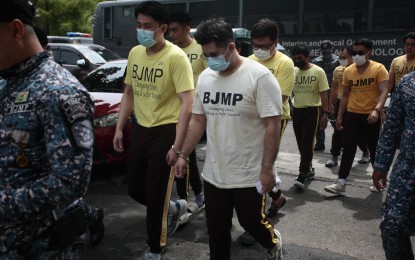 <p><strong>GUILTY.</strong> The 10 accused members of the Aegis Juris fraternity are escorted by jail guards for the promulgation of their case at the Manila Regional Trial Court (RTC) Branch 11 on Tuesday (Oct. 1, 2024). They were sentenced to up to 40 years imprisonment for the death of UST law student Horatio "Atio" Castillo lll. <em>(PNA photo by Ben Pulta)</em></p>