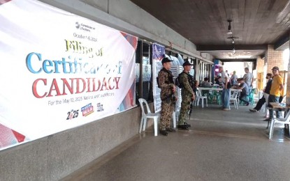 <p><strong>EARLY BIRDS.</strong> Two members of the Philippine National Police secure the Commission on Elections-Cebu City north and south offices in  downtown Cebu City on the first day of filing of the certificate of candidacy on Tuesday (Oct. 1, 2024). Comelec Chairperson George Erwin Garcia said during the National Information Summit 2024 in Tagaytay City that COCs would be posted on their official website two weeks after the deadline for filing on Oct. 8. <em>(PNA file photo by John Rey Saavedra) </em></p>