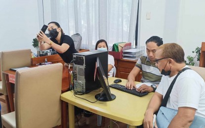 <p><strong>FIRST FILER.</strong> Jimmy Petil Merto (right) submits his certificate of candidacy at the Commission on Elections office in Dumaguete City on Tuesday (Oct. 1, 2024). Negros Oriental voters will elect officials for 277 positions in the May 2025 midterm elections.<em> (Photo courtesy of Comelec-NIR)</em></p>