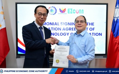 <p><strong>NEW INVESTOR.</strong> Philippine Economic Zone Authority Director General Tereso Panga (right) and EZconn Technology Corporation president Wen-Chan Yeh during the Registration Agreement signing at the PEZA Head Office in Pasay City on Sept. 26, 2024. EZconn is investing PHP70 million in an ecozone in Batangas. <em>(Courtesy of PEZA)</em></p>