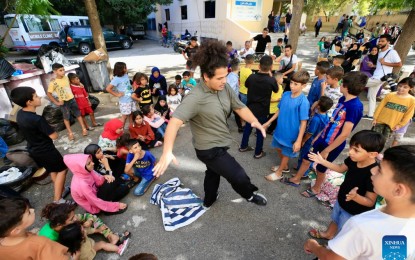 <p><strong>TEMPORARY RELIEF.</strong> A volunteer accompanies displaced children at a shelter in Sidon, southern Lebanon on Oct. 2, 2024. The total number of displaced persons in Lebanon due to Israeli airstrikes has risen to nearly 1.2 million, according to a report.<em> (Xinhua)</em></p>