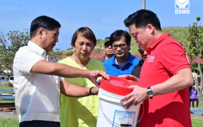 <p><strong>WATER FILTRATION KIT</strong>. Department of Social Welfare and Development Secretary Rex Gatchalian (right) demonstrates to President Ferdinand R. Marcos Jr. how the water filtration kit works in producing potable water during the chief executive’s visit to Basco, Batanes on Friday (Oct. 4, 2024). President Marcos was in the island province to lead the assessment and distribution of assistance to families affected by Super Typhoon Julian. <strong><em>(DSWD photo)</em></strong></p>