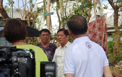 <p><strong>AID DISTRIBUTION.</strong> President Ferdinand R. Marcos Jr. leads the distribution of assistance to Batanes residents affected by the onslaught of Super Typhoon Julian, at the Oval Plaza in Basco town on Friday (Oct. 4, 2024). During the event, Marcos announced that the Office of the President would release PHP25 million for the typhoon victims. <em>(Photo courtesy of Malacañang Press Corps Pool)</em></p>