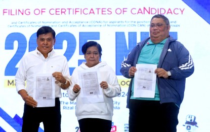 <p><strong>DAY 7. </strong>Multi-awarded actress Nora Aunor (center) files her certificate of nomination-certificate of acceptance of nomination as the second nominee of the People's Champ party-list. at The Manila Hotel Tent City on Monday (Oct. 7, 2024). A total of 99 aspirants -- 49 senatorial bets and 50 party-list groups -- filed their candidacy.<em> (PNA photo by Avito Dalan)</em></p>