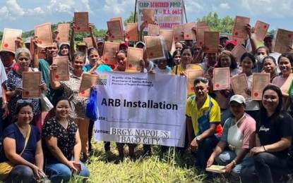 <p><strong>INSTALLED.</strong> The Department of Agrarian Reform awards titles and installs some 50 agrarian reform beneficiaries on the awarded landholdings in Barangay Busay, Bago City, Negros Occidental, on Oct. 4, 2024. “This is expected to provide the beneficiaries with opportunities for agricultural development and economic stability,” the DAR Municipal Office-Bago City said. <em>(Photo courtesy of DAR Negros Occidental II (South))</em></p>