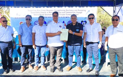 <p><strong>HOUSING FOR BADJAUS.</strong> Surigao City Mayor Pablo Yves Dumlao II and UN Resident Coordinator in the Philippines Gustavo Gonzales (4th and 5th from left) lead the turnover of the first model housing unit for Sama-Badjau residents in Barangay Lipata on Tuesday (Oct. 8, 2024). The first phase of the housing project will be completed by May 2025 to benefit some 20 Badjau residents. <em>(Photo courtesy of Surigao CIO)</em></p>