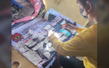 <p><strong>CONFISCATED DRUGS.</strong> An anti-drug operative conducts an inventory of the illegal drugs confiscated in an operation in Barangay Bakhaw in Iloilo City on Wednesday (Oct. 9, 2024). Also confiscated from the suspect was a caliber .38 revolver and ammunition. <em>(Photo courtesy of ICPO)</em></p>