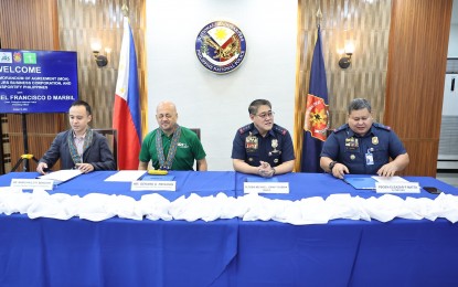 <p><strong>FIGHTING DRUG TRAFFICKING.</strong> Officials of the Philippine National Police and two logistics firms sign a memorandum of agreement (MOA) in simple rites at Camp Crame, Quezon City on Thursday (Oct. 10, 2024). The PNP said Friday (Oct. 11, 2024) that the MOA provides for effective collaboration between the force and its partner logistics firms in fighting drug trafficking through the use of transport and delivery services. <em>(Photo courtesy of PNP)</em></p>