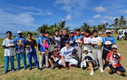 <p><strong>PITCHED IN.</strong> Japanese baseball legend Tsuyoshi Yoda (front row, in jersey) poses with young baseball enthusiasts in Mulanay, Quezon after an exhibition game on Sunday (Oct. 13, 2024). Yoda, who also visited the town in January upon the invitation of Mayor Aris Aguirre, conducted a clinic the day before. <em>(Photo courtesy of Mulanay PIO)</em></p>