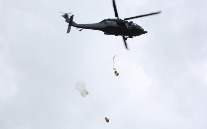 <p><strong>AIRDROP.</strong> Philippine Air Force's (PAF) S-70i Black Hawk helicopter during a Bundle Drop operation exercise, one of the activities of the just-concluded Interoperability Exercise (IOX) 03-24 at the 5th Infantry Division at the Camp Melchor F. Dela Cruz in Gamu town, Isabela province. The PAF and the Philippine Army held a joint military exercise from Oct. 7 to 11, 2024. <em>(PAF Photo)</em></p>