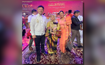 <p><strong>NATIONAL PRIDE.</strong> Raihana Ambangala (center) poses with National Commission on Muslim Filipinos (NCMF) Secretary Sabuddin Abdurahim (left) and Philippine Ambassador to Malaysia Maria Angela Ponce after placing second in the female recital category of the 64th International Al-Qur’an Recital and Memorization Assembly in Kuala Lumpur, Malaysia on Oct. 12, 2024. The NCMF said Ambangala’s win brought home pride to the country. <em>(Photo courtesy of NCMF)</em></p>