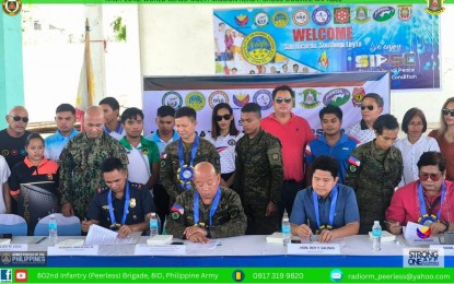 <p><strong>PEACEFUL TOWN.</strong> Officials from the Philippine Army and the local government of San Ricardo, Southern Leyte sign a memorandum of agreement on the declaration of the town as free from threats of New People's Army rebels at the municipal covered court on Oct. 11, 2024. The declaration, according to the military, marks a significant milestone in the ongoing efforts to maintain peace and stability.<em> (Photo courtesy of Philippine Army)</em></p>