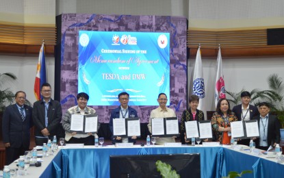 <p><strong>OFWS UPSKILLING</strong>. The Department of Migrant Workers (DMW) and the Technical Education and Skills Development Authority (TESDA) officials inked a memorandum of agreement at the TESDA office in Taguig City on Tuesday (Oct. 15, 2024). The agreement aims to enhance the skills and employability of the overseas Filipino workers.<em> (Photo courtesy of DMW)</em></p>