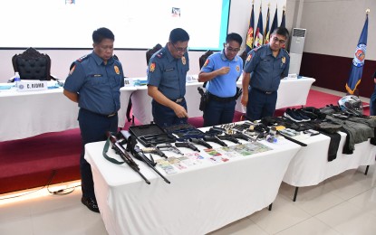 <p><strong>SWIFT ACTION.</strong> Officials of the Police Regional Office 3 inspect the firearms and explosives seized from the suspects in the killing of online seller couple Arvin and Lerma Lulu at its headquarters in San Fernando City, Pampanga on Tuesday (Oct. 15, 2024). The PRO 3 nabbed the seven suspects in the crime in two-day focused operations from Oct. 13 to 14. <em>(Photo courtesy of PRO 3)</em></p>