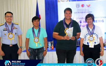 <p><strong>MARITIME SAFETY.</strong> Surigao City Mayor Pablo Yves Dumlao II (2nd from right) and Regional Director Ninfa Martinez (right) of the Maritime Industry Authority-13 sign a memorandum of understanding on Tuesday (Oct. 15, 2024) to ensure the safety of sea travelers in the area especially those residing in island barangays. Thousands of residents in Surigao City currently reside in 21 island barangays.<em>(Photo courtesy of Surigao CIO)</em></p>