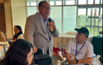 <p><strong>FIGHTING CYBERCRIME</strong>. Cybercrime Investigation and Coordinating Center (CICC) Executive Director Alexander Ramos (standing) meets the media on the sidelines of his talk at a training workshop on campus journalism in Baguio City on Thursday (March 13, 2025). He said they are encouraging educators to incorporate the topic on cybercrime and artificial intelligence in their subjects.<em> (Screenshot from video of Emil Peredo)</em></p>