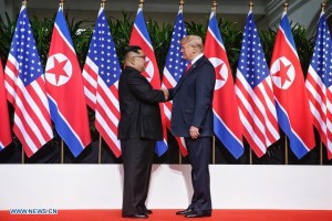 Kim, Trump shake hands at historic summit