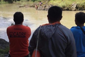 Search for 2 men swept by strong river current continues