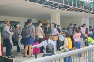 Domestic passengers undergo thermal scanning in Kalibo airport