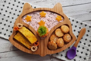 Mom prepares appetizing food to keep toddler healthy