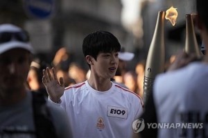 BTS' Jin carries Paris Olympics torch amid cheers from fans